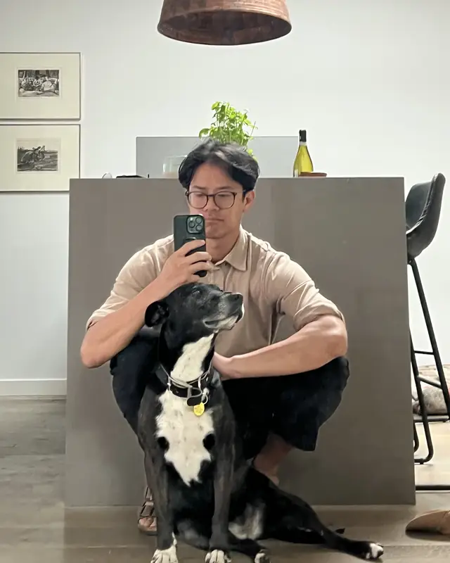 James crouching with his dog